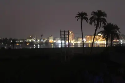 a city at night with palm trees and lights at Villa-Djorf Westbank in Al Aqālitah