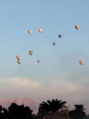 a group of hot air balloons flying in the sky at Villa-Djorf Westbank in Al Aqālitah