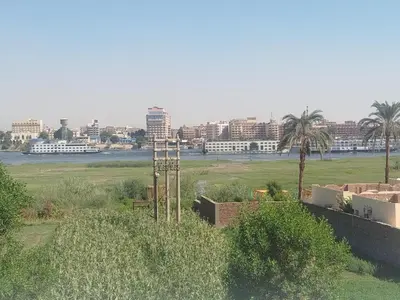 a view of a field with a city in the background at Villa-Djorf Westbank in Al Aqālitah