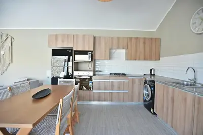 a kitchen with a table and a dining room at Bali - ELGOUNA - Premium Chalet with private pool in Hurghada