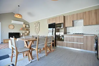 a kitchen and dining room with a table and chairs at Bali - ELGOUNA - Premium Chalet with private pool in Hurghada