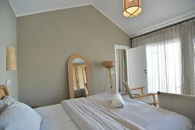 a bedroom with a large white bed and a mirror at Bali - ELGOUNA - Premium Chalet with private pool in Hurghada