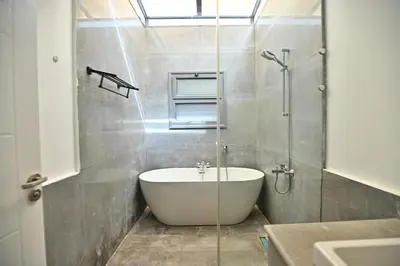 a bathroom with a bath tub and a sink at Bali - ELGOUNA - Premium Chalet with private pool in Hurghada