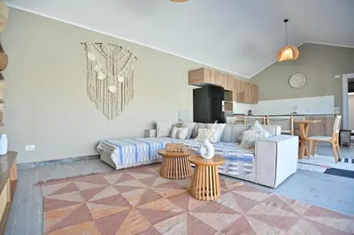 a living room with a couch and a table at Bali - ELGOUNA - Premium Chalet with private pool in Hurghada