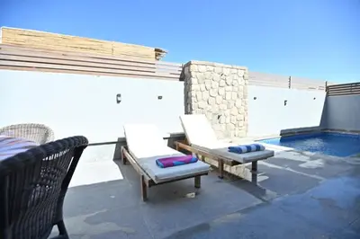 a patio with two chairs and a swimming pool at Bali - ELGOUNA - Premium Chalet with private pool in Hurghada