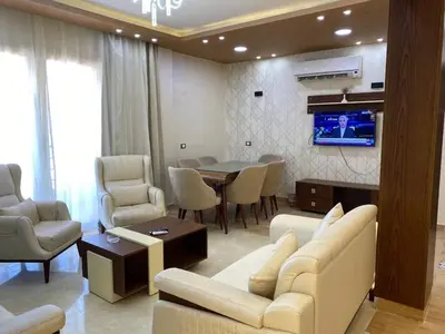 a living room with a couch and a dining room at Flat on the Sea in Hurghada