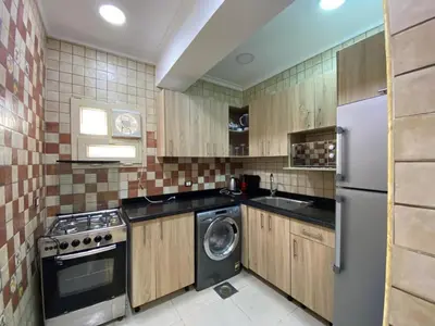a kitchen with a refrigerator and a washer and dryer at Star Beach in Hurghada