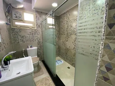 a bathroom with a shower and a toilet and a sink at Star Beach in Hurghada