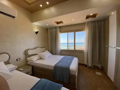 a hotel room with two beds and a window at Star Beach in Hurghada
