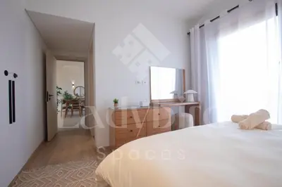 a white bedroom with a large bed and a mirror at Ladybird - Kamaran Pearl in Hurghada