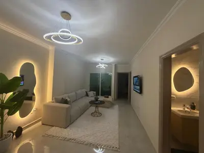 a living room with a couch and a table at Stylish home & Free transfers in Hurghada