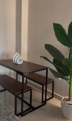 a table and two chairs and a plant at Stylish home & Free transfers in Hurghada