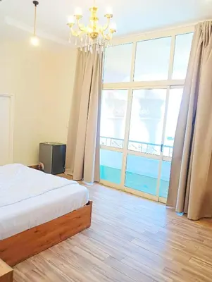 a bedroom with a bed and a large window at VIP hotel & café in Qilfāw