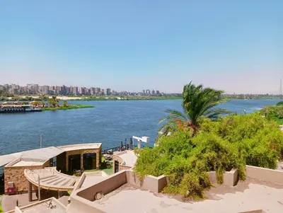 a view of a river with a city in the background at VIP hotel & café in Qilfāw