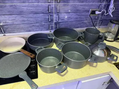 a bunch of pots and pans on a kitchen counter at Hub Hurghada Two Bedroom Luxury Apartment in Hurghada