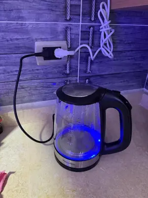 an electric kettle with a fish in it plugged into an outlet at Hub Hurghada Two Bedroom Luxury Apartment in Hurghada