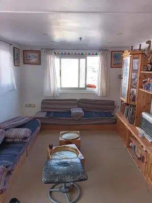 a room with two beds and a window at Shellaly Ca Nubian Heritage House in Jazīrat Salūjah