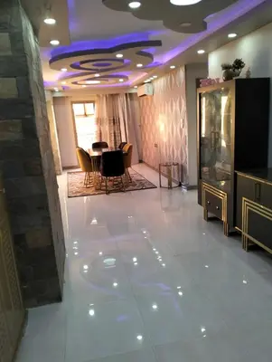 a lobby with a table and chairs and a purple ceiling at Luxury house in Luxor