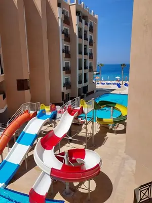 a water slide at a resort with a pool at فندق جوليانا بيتش in Hurghada