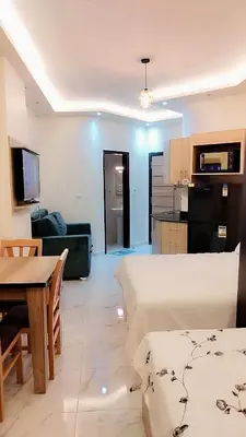 a living room with a couch and a table and a kitchen at فندق جوليانا بيتش in Hurghada