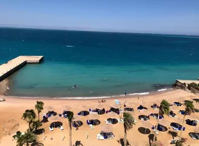 an aerial view of a beach with umbrellas and the ocean at Juliana Beach Resort, Hurghada in Hurghada