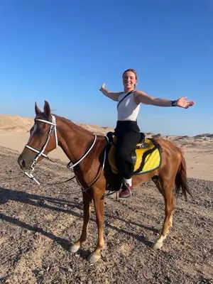 a woman riding on a horse in the desert at Horse Riding Tour in Hurghada