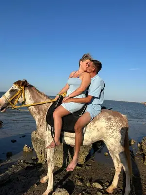 a man and a woman riding a horse on the beach at Horse Riding Tour in Hurghada