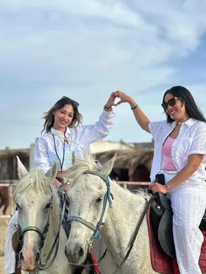 two women riding on a white horse at Horse Riding Tour in Hurghada