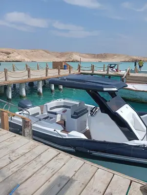 a boat is docked at a dock in the water at Speed Boat Tour Hurghada 4 Hours in Hurghada