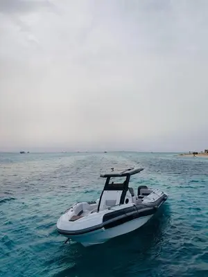a white boat on the water in the ocean at Speed Boat Tour Hurghada 4 Hours in Hurghada