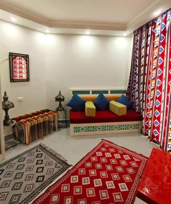 a living room with a red couch and a window at Holiday Seaview Home I Near Palacio Hotel I WIFI in Hurghada