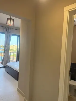 a bedroom with a bed and a window at Yoke 2 bedrooms Duplex Tawila ElGouna, Plaza gouna in Hurghada