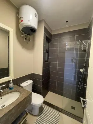 a bathroom with a toilet and a sink and a shower at Lovely 1 bd apartment with amazing view in Tawila in Hurghada