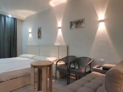 a hotel room with a bed and a couch at Modern Downtown Apartment In Scandic Resort WiFi Beach Front in Hurghada