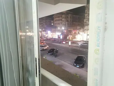a view of a city street at night from a window at Modern Downtown Apartment In Scandic Resort WiFi Beach Front in Hurghada