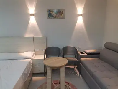 a room with a bed and a couch and a table at Modern Downtown Apartment In Scandic Resort WiFi Beach Front in Hurghada