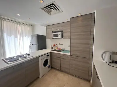 a kitchen with a washer and dryer in it at 2bd direct on the pool in Scarab El Gouna in Hurghada