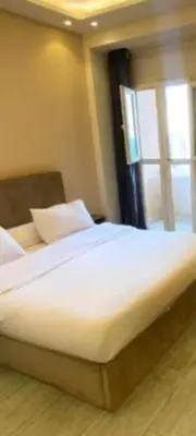 a large bed in a room with a window at Apartment for daily rent free beach access in Hurghada