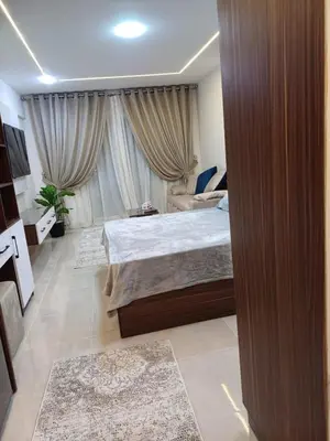 a bedroom with a bed and a large window at Tiba Golden Resort Hurghada in Hurghada
