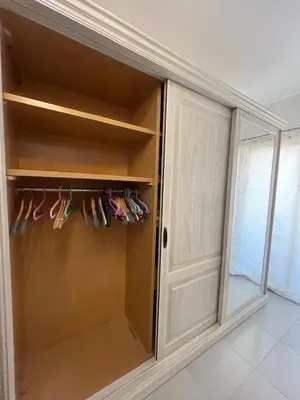 a closet with a door and some pairs of shoes at Benashti Hurghada apartment in Hurghada