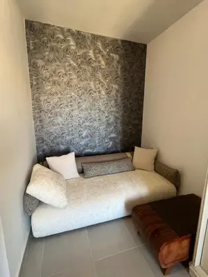 a couch sitting in a corner of a room at Benashti Hurghada apartment in Hurghada