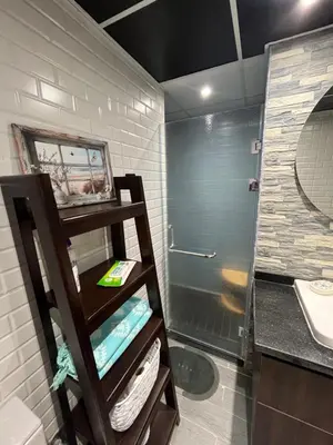 a bathroom with a shower and a sink and a mirror at Benashti Hurghada apartment in Hurghada