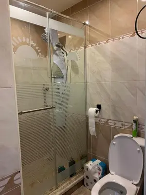a bathroom with a toilet and a glass shower at Appartement hurghada gravity beach in Hurghada