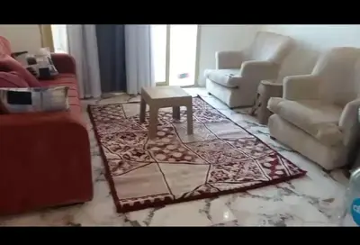 a living room with couches and a table on a rug at منتجع سياحي ميراج باي الغردقة in Hurghada