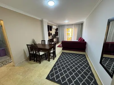 a living room with a couch and a table at 2 bedroom furnished apartment in Hurghada