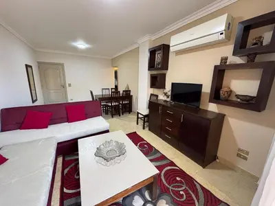 a living room with a couch and a table at 2 bedroom furnished apartment in Hurghada