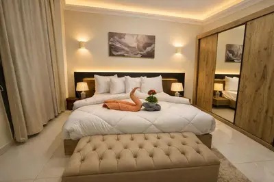 a bedroom with a bed with a stuffed dinosaur on it at Star Luka Private Hotel Room in Luxor