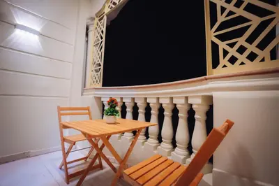 a small table and chairs in a room with a blackboard at Star Luka Private Hotel Room in Luxor