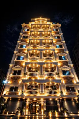 a tall building with lights on it at night at Star Luka Private Hotel Room in Luxor