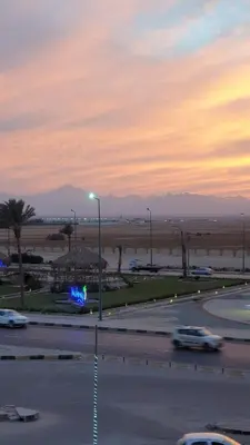 a parking lot with a street light and cars on a road at Arietta Flat Amazing location in Avrio compound in Hurghada